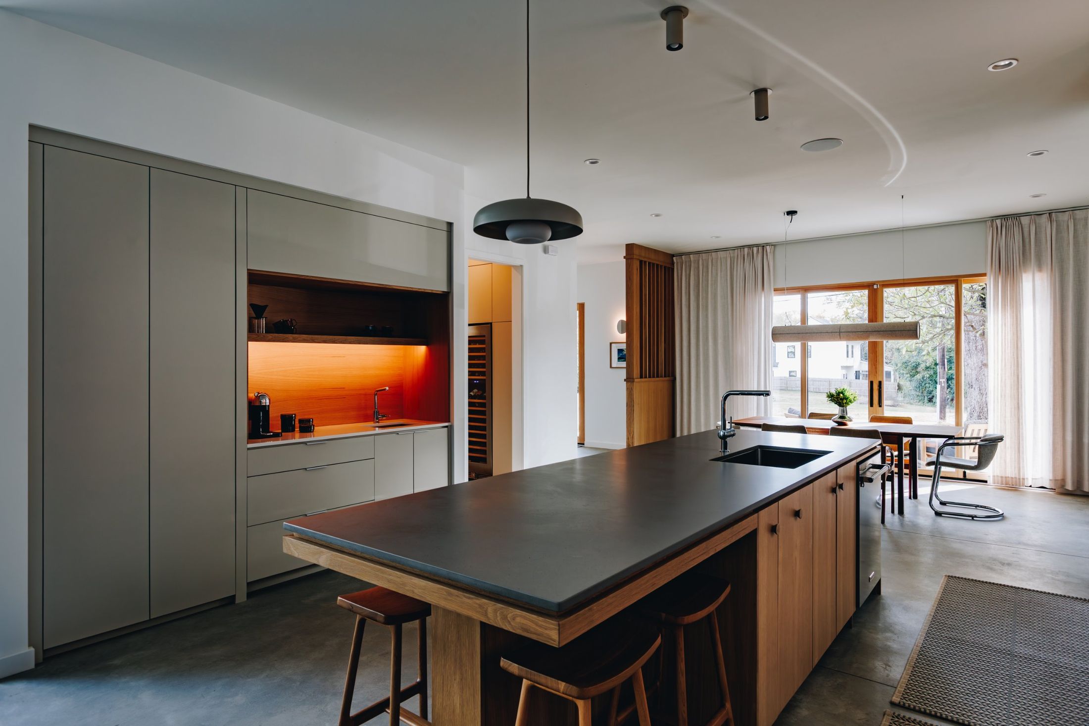 Kitchen coffee niche glowing orange inside gray flat-panel cabinetry