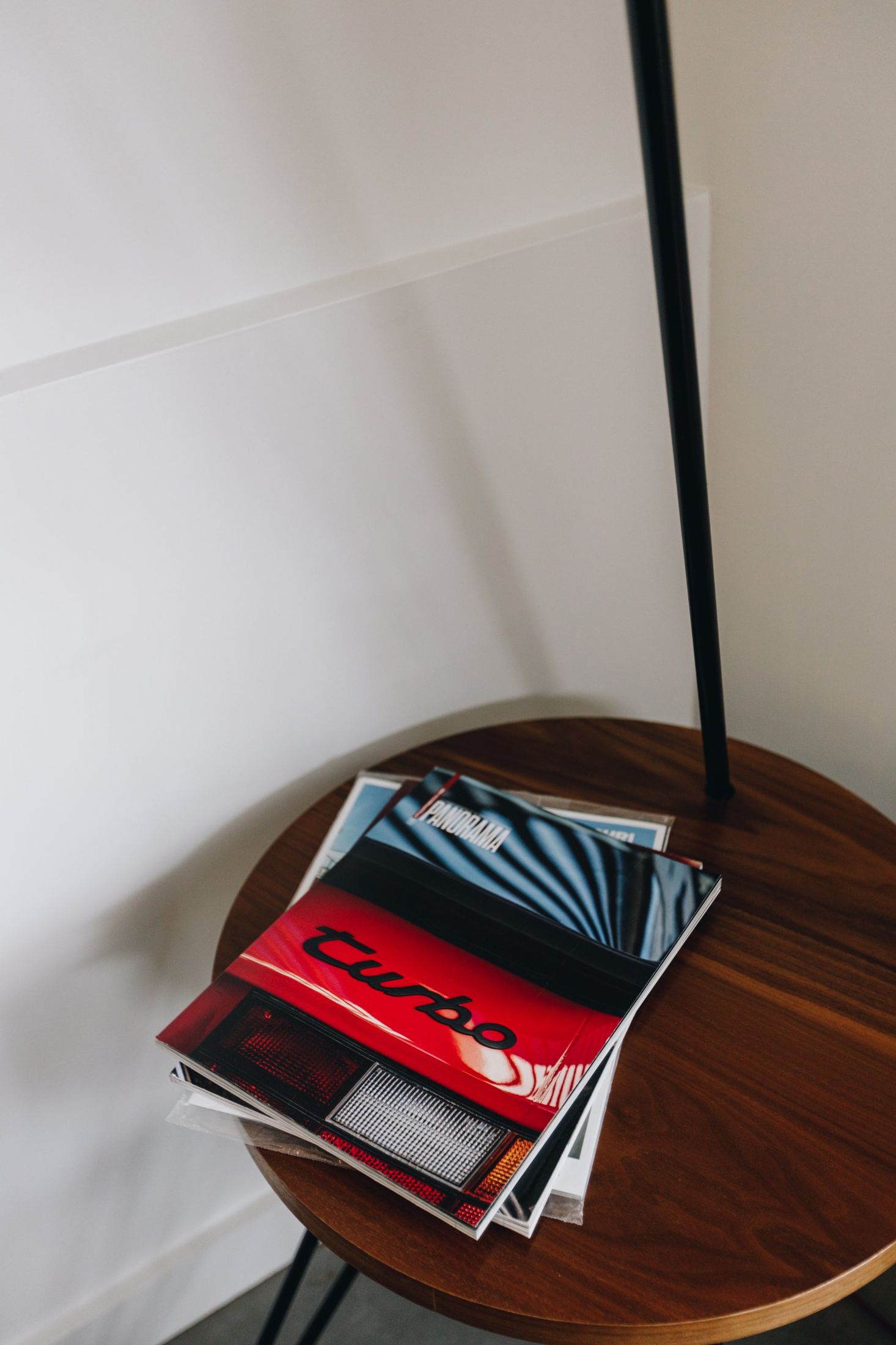 Porsche Turbo magazine on a walnut side table